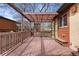Wooden deck features a pergola, wooden bench, and a view of the fenced yard at 673 Brentwood St, Lakewood, CO 80214