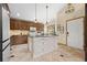 Spacious kitchen with wooden cabinets, an island, and modern appliances at 673 Brentwood St, Lakewood, CO 80214