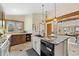 Spacious kitchen featuring an island, wooden cabinets, and granite countertops with an open view at 673 Brentwood St, Lakewood, CO 80214