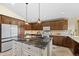 Gourmet kitchen featuring a large island with granite countertops and custom wood cabinetry at 673 Brentwood St, Lakewood, CO 80214