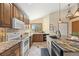 Kitchen showcasing granite countertops, wooden cabinets, and stainless steel appliances at 673 Brentwood St, Lakewood, CO 80214
