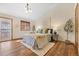 Bright and airy main bedroom with wood floors, neutral walls, and modern decor at 673 Brentwood St, Lakewood, CO 80214