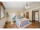 Bright and airy main bedroom with wood floors, neutral walls, and modern decor at 673 Brentwood St, Lakewood, CO 80214