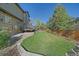 Spacious backyard with mature trees offers a private oasis, deck for entertaining, and play area at 10127 W 100Th Ct, Westminster, CO 80021