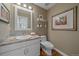 Stylish half bathroom with granite countertop, modern fixtures, and hardwood floors at 10127 W 100Th Ct, Westminster, CO 80021