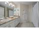 Bright bathroom with double vanity, granite countertops and tile floor at 10127 W 100Th Ct, Westminster, CO 80021