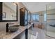 Modern bathroom featuring double sinks, granite countertops, and a glass-enclosed shower at 10127 W 100Th Ct, Westminster, CO 80021