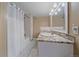 Bathroom with granite countertops, white cabinets, and a shower/tub combo with white tile at 10127 W 100Th Ct, Westminster, CO 80021