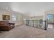 Upstairs bonus room with neutral carpet, railing and chair at 10127 W 100Th Ct, Westminster, CO 80021