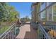 Large deck features seating, a fire pit, and views of the green backyard at 10127 W 100Th Ct, Westminster, CO 80021
