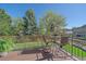Back deck features seating and views of the backyard and mature landscaping at 10127 W 100Th Ct, Westminster, CO 80021