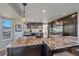 Open-concept kitchen with an island, granite countertops, stainless steel appliances, and ample storage at 10127 W 100Th Ct, Westminster, CO 80021