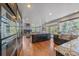 Modern kitchen with a large island, stainless steel appliances, and an open view to the living area, perfect for cooking at 10127 W 100Th Ct, Westminster, CO 80021