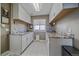 Functional laundry room featuring white cabinets, granite countertops, and ample storage space at 10127 W 100Th Ct, Westminster, CO 80021