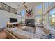 Bright living room with a fireplace, large windows, and hardwood floors, overlooked by a second-story balcony at 10127 W 100Th Ct, Westminster, CO 80021