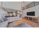 Open-concept living room with hardwood floors, sleek furniture, and views of the kitchen, ideal for modern living at 10127 W 100Th Ct, Westminster, CO 80021