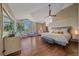 Bright main bedroom features hardwood floors, large windows, and stylish décor at 10127 W 100Th Ct, Westminster, CO 80021