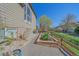 Side yard of home features a flower bed, privacy, and path to walking trails at 10127 W 100Th Ct, Westminster, CO 80021