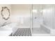 Elegant bathroom with soaking tub, glass-enclosed shower, and patterned tile flooring at 9388 E 59Th Pl, Denver, CO 80238