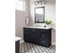 Modern bathroom with dark vanity, quartz countertop, decorative tile flooring and chrome hardware at 9388 E 59Th Pl, Denver, CO 80238