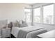 Cozy bedroom with natural light, comfortable bedding, and a serene, minimalist design at 9388 E 59Th Pl, Denver, CO 80238