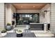 Relax on this covered patio with a fireplace, tv, and sliding glass doors to bring the outside in at 9388 E 59Th Pl, Denver, CO 80238
