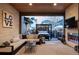 A covered patio boasting an outdoor seating area, outdoor kitchen, fireplace, and view of hot tub at 9388 E 59Th Pl, Denver, CO 80238