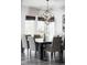 Dining space with a modern light fixture, seating for eight, and views of the outdoors at 9388 E 59Th Pl, Denver, CO 80238
