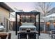 The beautiful hot tub with a pergola and lights sits next to the grill and outdoor dining area at 9388 E 59Th Pl, Denver, CO 80238