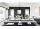 Elegant living room with a large sectional sofa, mirrored console, and a sliding glass door to the patio at 9388 E 59Th Pl, Denver, CO 80238