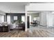 Bright living room with hardwood floors, neutral-toned furnishings, and an adjacent glass-walled office space at 9388 E 59Th Pl, Denver, CO 80238