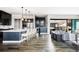 Open-concept living space with a gourmet kitchen, bar area, and sliding doors to the outdoor living space at 9388 E 59Th Pl, Denver, CO 80238