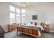 Bright main bedroom with high windows, wood furniture, and a comfortable, inviting decor at 9388 E 59Th Pl, Denver, CO 80238