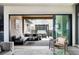 Inviting outdoor patio with comfortable seating, a pergola, and sliding doors to the living room at 9388 E 59Th Pl, Denver, CO 80238