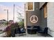 This beautiful patio has blue outdoor furniture, decorative string lights, and a peace sign wall decoration at 9388 E 59Th Pl, Denver, CO 80238