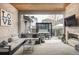 Inviting outdoor patio with a cozy seating area, hot tub, fireplace, and TV at 9388 E 59Th Pl, Denver, CO 80238