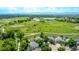 The house has an aerial view showing the park behind with paths, lake, and mountain backdrop at 1588 W 111Th Ave, Northglenn, CO 80234