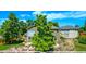 Expansive backyard features a patio with seating, water feature, and mature trees providing shade at 1588 W 111Th Ave, Northglenn, CO 80234