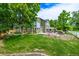 Beautiful backyard with lush green grass, mature trees, and a patio with a gazebo, perfect for outdoor living at 1588 W 111Th Ave, Northglenn, CO 80234