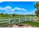 A serene backyard featuring a white fence with mountain views and a stone fire pit area at 1588 W 111Th Ave, Northglenn, CO 80234