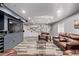 Basement featuring a large entertainment center, leather seating, unique wall decor, and contemporary design at 1588 W 111Th Ave, Northglenn, CO 80234