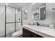 Contemporary bathroom featuring a marble countertop, dark wood vanity, and a glass shower, adding a luxurious feel at 1588 W 111Th Ave, Northglenn, CO 80234