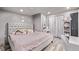 Bright bedroom with a tufted headboard, plush bedding, and a makeup vanity, creating a cozy, inviting space at 1588 W 111Th Ave, Northglenn, CO 80234