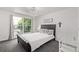 Well-lit bedroom offering a large window, chandelier, dark wood frame bed, and neutral colors at 1588 W 111Th Ave, Northglenn, CO 80234