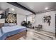 Spacious bedroom featuring wood floors, a bed, exposed beam, and an entertainment center for modern living at 1588 W 111Th Ave, Northglenn, CO 80234