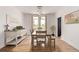 Bright dining room with hardwood floors, modern lighting fixture, and large windows at 1588 W 111Th Ave, Northglenn, CO 80234