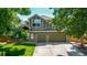 Charming two-story home with a well-manicured lawn, mature trees, and a three-car garage at 1588 W 111Th Ave, Northglenn, CO 80234