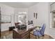 Bright home office with hardwood floors, a modern desk, and views of the stairway and front yard at 1588 W 111Th Ave, Northglenn, CO 80234