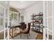 Elegant home office featuring French doors, a stylish desk, and built-in shelving at 1588 W 111Th Ave, Northglenn, CO 80234