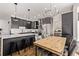 Open-concept kitchen featuring stainless steel appliances, a large island, and an adjacent dining area at 1588 W 111Th Ave, Northglenn, CO 80234